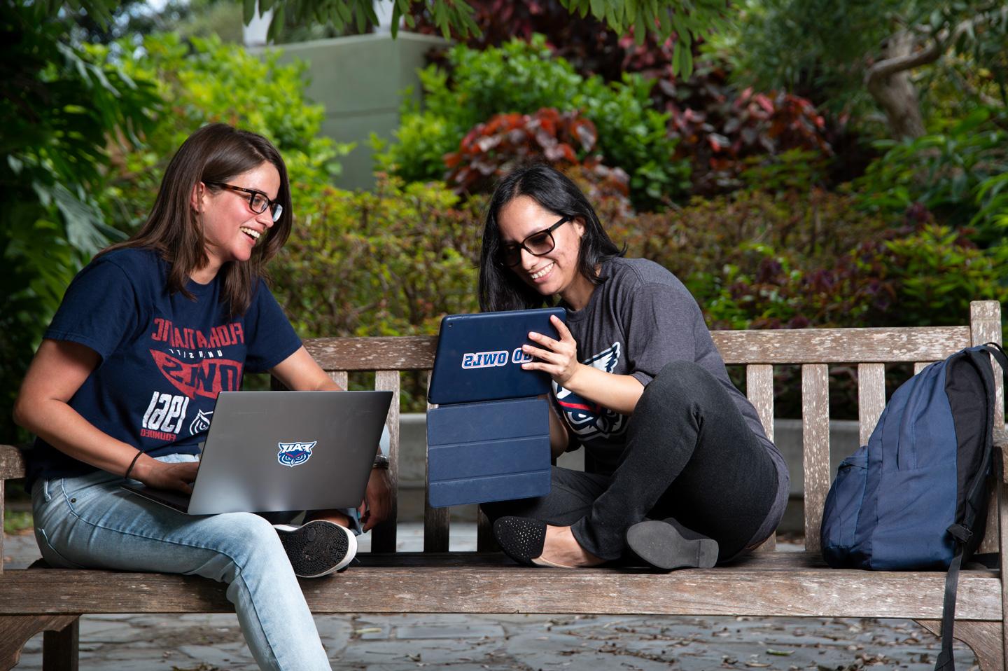 Two people looking at a computer